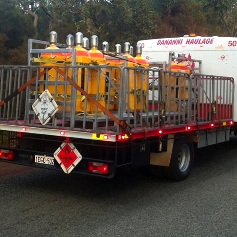 Dananni Haulage truck loaded with placarded dangerous goods cylinders